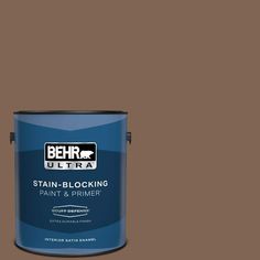 the behr ultra stain blocking paint and primer is shown in an open brown tin