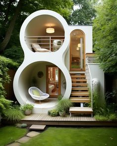 an unusual house in the middle of a garden with stairs leading up to it's second floor