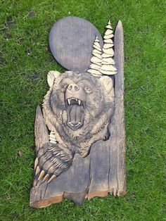 a bear carving on top of a piece of wood