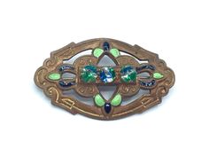 "* Small Edwardian brooch c late 1910s - early 1920s * Stamped and cut-out coppertone metal base features green and black enameling, 3 aquamarine rhinestones across center * Simple pin back No markings Excellent condition Length: 1.5\" Width: 1\" Please view my shop policies prior to placing an order as all sales are final: http://www.etsy.com/shop/ranchqueenvintage/policy ❤ Note to my dear international buyers: Please check with your postal service about all customs and duty fees imposed by you Antique Green Filigree Brooches, 20s Costume, Early 20s, 1910s Fashion, Stamped Metal, Simple Pins, 20s Fashion, Antique Clothing, Pin Backs