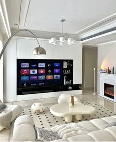 a large flat screen tv mounted on the wall in a living room next to a fire place