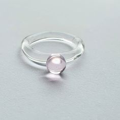 Contemporary, minimal glass ring, delicate but strong. I handmake each ring individually in the torch flame from borosilicate glass, combining a clear band with transparent colour droplet. This style is comfortable to wear and perfect for a minimal splash of colour. It's also fun to stack with complementary or contrasting colours and shapes. This listing is for a delicate baby pink dot glass ring. All glass is individually handmade by myself and is kiln annealed for durability. Glass Ring, Minimalist Adjustable Glass Jewelry, Minimalist Glass Jewelry With Adjustable Chain, White Minimalist Glass Jewelry, Small Glass Rings, Gold Globe, Zierlicher Ring, Contemporary Glass, Glass Rings