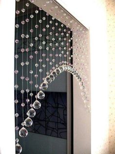 a mirror with beads hanging from it's side