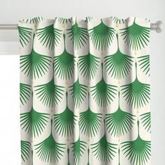 a green and white curtain with palm leaves on it