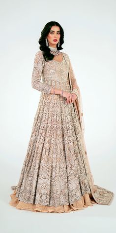 Pakistani Bridal Outfit in Wedding Lehenga Gown Style is a premium quality masterpiece that will give the gorgeous bride a head-turning trendy and traditional look on the wedding. Luxurious fabric makes this heavily embellished Pakistani Bridal Dress an epitome of beauty and grace. Pakistani Bridal Gown: Pakistani Bridal Gown in a beautiful pink color is intricately adorned with jaal work of shimmering silver details. This beautiful Pakistani Gown is beautifully adorned with shimmering embellishments. Resham, dabka, crystals, sequins, and pearls enhance the glamour of this Pakistani Bridal Outfit. Bridal Lehenga: Pakistani Bridal Gown is paired with a huge flared Lehenga. The Bridal Lehenga has a huge flare and it comes in an alluring pink shade. The fabric of this stunning Wedding Lehenga