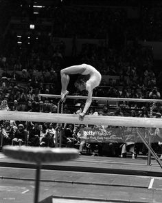 a man on a balance beam in front of an audience at a circus show stock photo