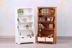 a white bookcase next to a wooden shelf with books on it and a potted plant