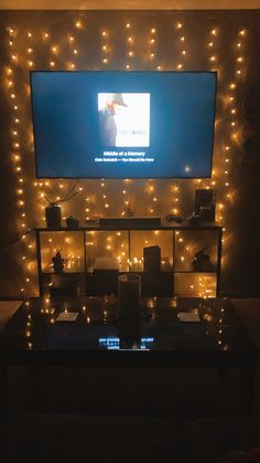 a living room with lights on the wall and a flat screen tv mounted above it