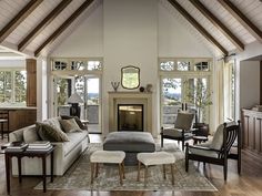 a living room filled with furniture and a fire place in the middle of a room