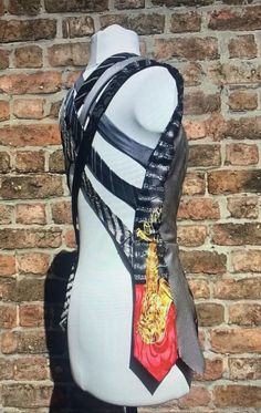 a mannequin wearing a black and white top with chains on it's back