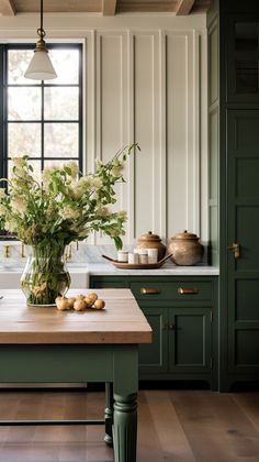 a kitchen with green cabinets and wooden counter tops