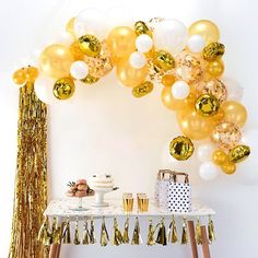 a table topped with balloons and confetti