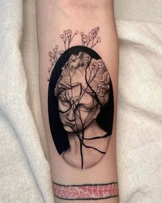 a woman's face with flowers and vines on her arm, as if it were in a circle