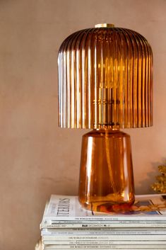 a table lamp sitting on top of some books