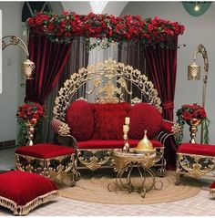 a living room filled with red and gold furniture