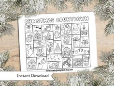 a printable christmas count down game on top of a wooden table with pine branches