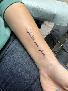 a woman with a tattoo on her arm that says, i am not here yet