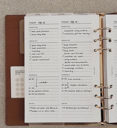 an open planner book sitting on top of a table