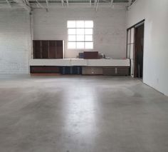 an empty room with white walls and windows