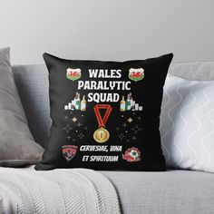 a black throw pillow with the words wales paralytic squad on it and medals