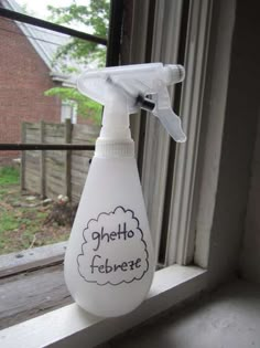 a white spray bottle sitting on top of a window sill