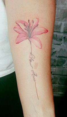 a woman's arm with a pink flower tattoo on the left side of her arm