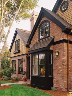 a brick house with black trim and windows