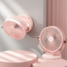 a pink fan sitting on top of a white table