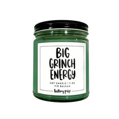 a green candle with the words, big grin energy on it's label in black lettering