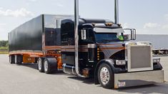 a semi truck is parked on the side of the road