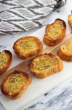 small pastries sitting on top of a cutting board