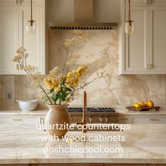 a kitchen with marble counter tops and yellow flowers in a vase on the stove top