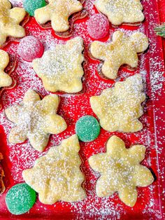 christmas cookies are arranged on a red tray