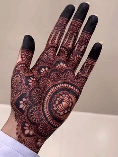 a person's hand with henna tattoos on it