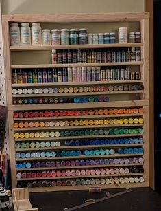 a shelf filled with lots of different types of paint