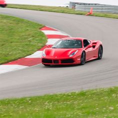 a red sports car driving on a race track