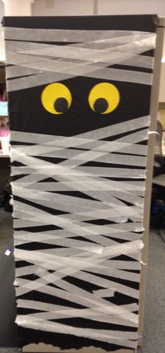 an office cubicle decorated to look like a cat with yellow eyes and black stripes