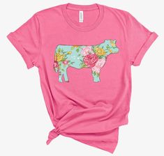 a pink t - shirt with a cow on it's chest and flowers around the neck