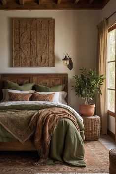 a bedroom with a large bed and potted plant in the corner next to it