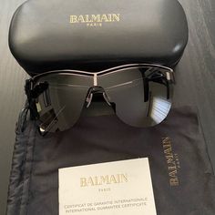 Black Balmain Sunglasses. Never Worn. Comes With Certificate, Bag, And Case. Luxury Shield Sunglasses With Mirrored Lenses For Evening, Luxury Evening Shield Sunglasses With Mirrored Lenses, Designer Black Shield Sunglasses For Party, Designer Shield Sunglasses With Tinted Lenses For Evening, Chic Black Shield Sunglasses For Evening, Designer Tinted Shield Sunglasses For Evening, Balmain Handbags, Balmain Earrings, Balmain Paris Bag