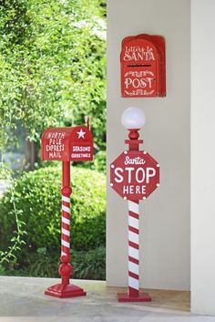 two red and white street signs next to each other