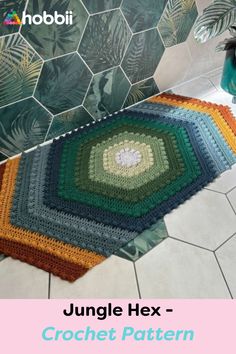 a crocheted rug is on the floor in front of a tiled wall and shower