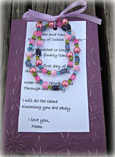 a card with beads on it and a ribbon tied around the clasp that says, i love you mom