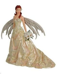 a figurine of a woman in a wedding dress with wings on her head