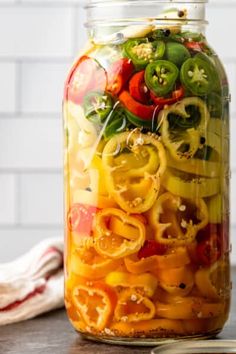 a mason jar filled with sliced bell peppers and onions