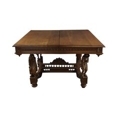 an old wooden table with carvings on the legs and top, against a white background