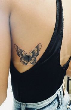 a woman with a butterfly tattoo on her back