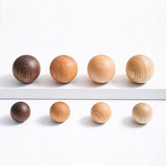 six wooden balls lined up on top of each other