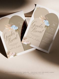 two folded wedding cards with flowers on them