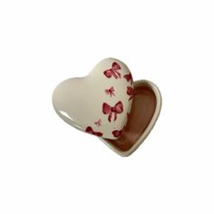 a white and red heart shaped dish with butterflies on it's side, sitting in front of a white background